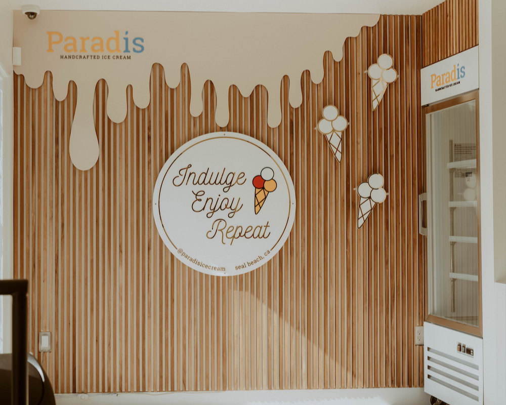 Ice cream-themed wall design with 'Paradis' branding in a room.
